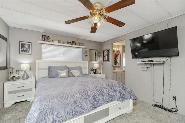bedroom with a sink, ensuite bathroom, carpet, and a ceiling fan