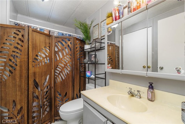 bathroom with vanity, a shower with curtain, and toilet