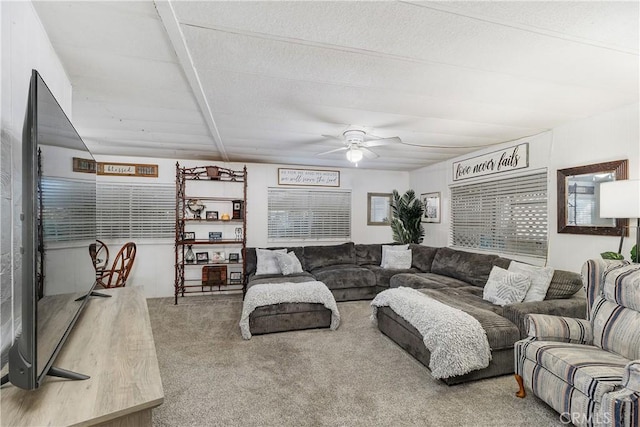 carpeted living room featuring a ceiling fan