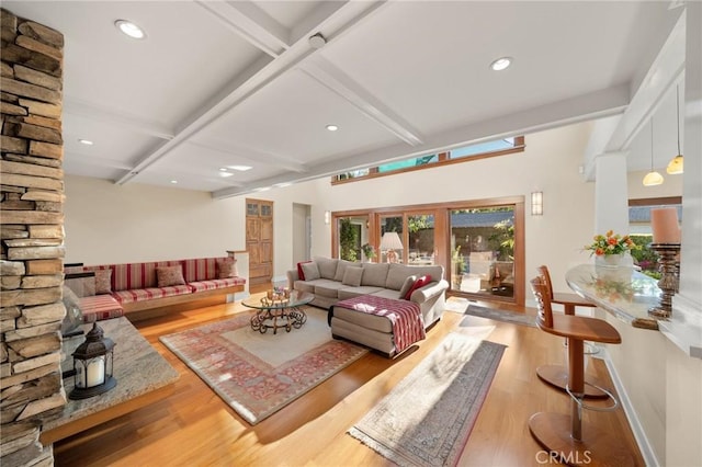 living room featuring beamed ceiling, coffered ceiling, and wood finished floors