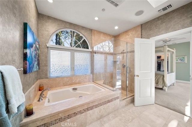 ensuite bathroom with tile patterned floors, a shower stall, a garden tub, and visible vents