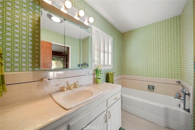 bathroom with vanity, a garden tub, and wallpapered walls