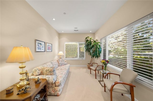 living area featuring baseboards, carpet flooring, recessed lighting, and a wealth of natural light