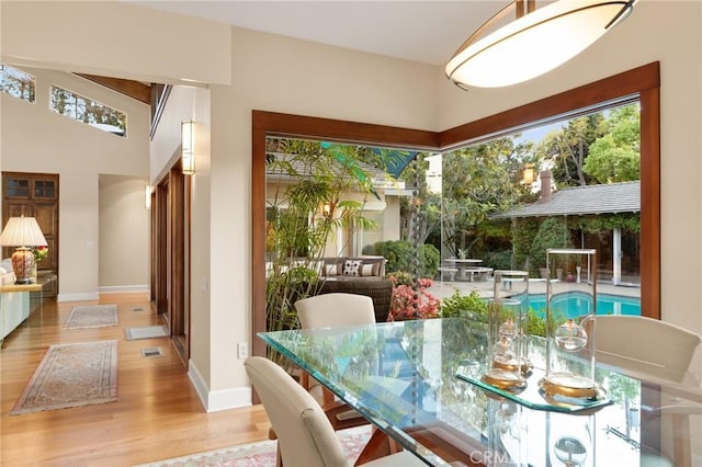dining space with baseboards and wood finished floors
