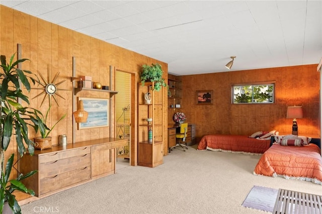 bedroom featuring carpet floors and wood walls