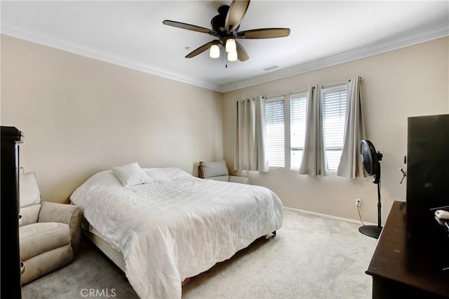 bedroom with a ceiling fan, visible vents, crown molding, baseboards, and carpet flooring