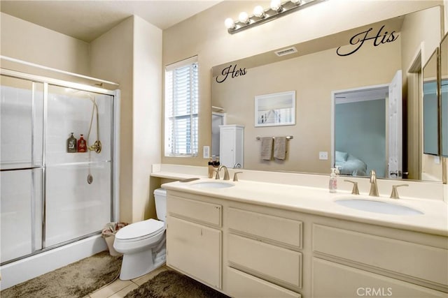 ensuite bathroom featuring a sink, tile patterned floors, a shower stall, and visible vents