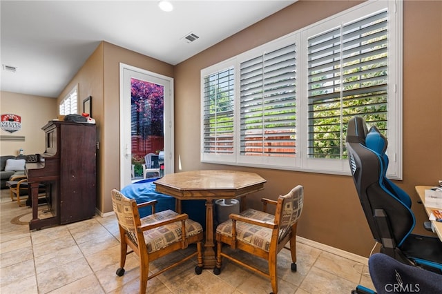 dining space with baseboards, visible vents, and light tile patterned floors
