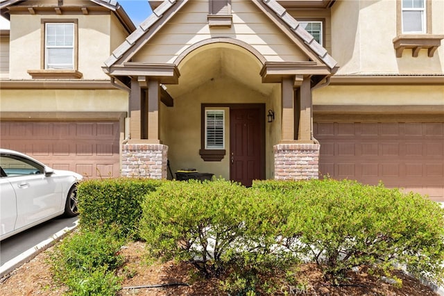 9133 Arbol Del Rosal Way Unit 230, Atascadero, CA 93422 - view of front of home with an attached garage, stucco siding, and stone siding