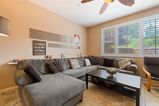 living room featuring baseboards, tile patterned flooring, and a ceiling fan