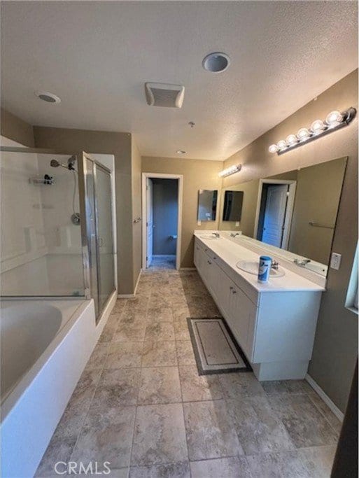 9133 Arbol Del Rosal Way Unit 230, Atascadero, CA 93422 - full bath featuring a shower with shower door, double vanity, a tub, and a textured ceiling