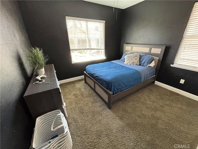 carpeted bedroom with baseboards and multiple windows