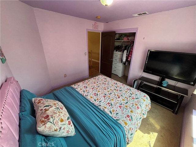 carpeted bedroom featuring visible vents and a closet