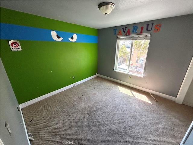 unfurnished bedroom with baseboards and carpet