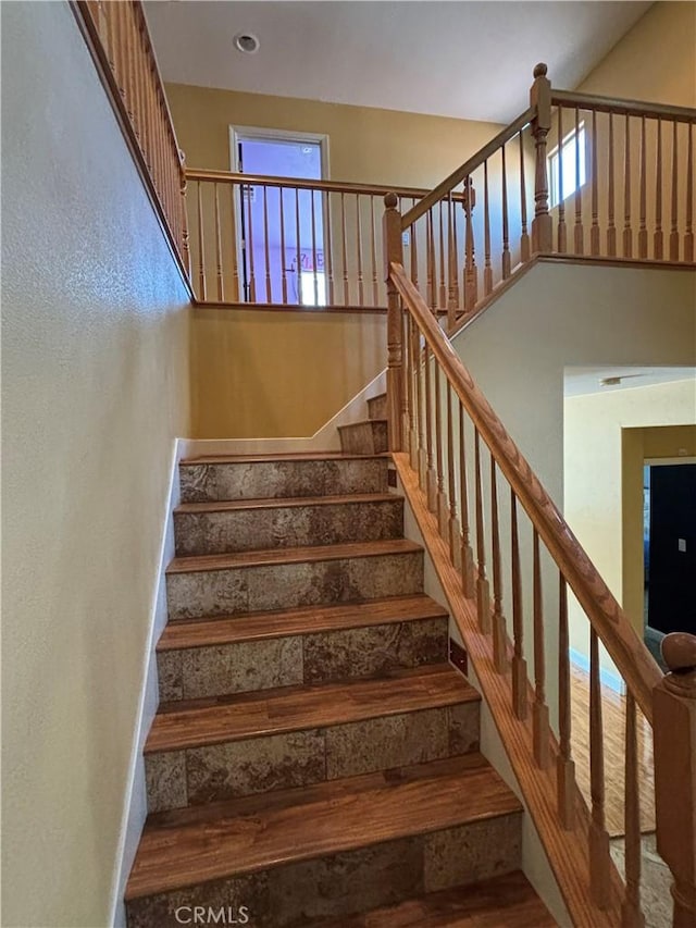 stairway with wood finished floors