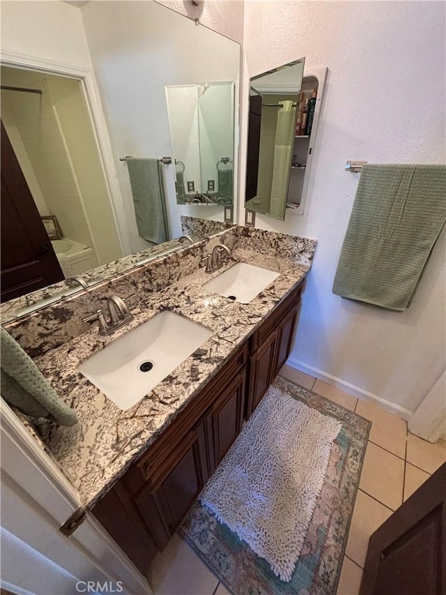 full bathroom featuring double vanity, a sink, and tile patterned flooring