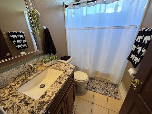bathroom featuring vanity, tile patterned floors, toilet, and a shower with curtain