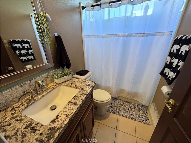 343 San Bernardino St, Los Banos, CA 93635 - bathroom with toilet, vanity, tile patterned flooring, and curtained shower