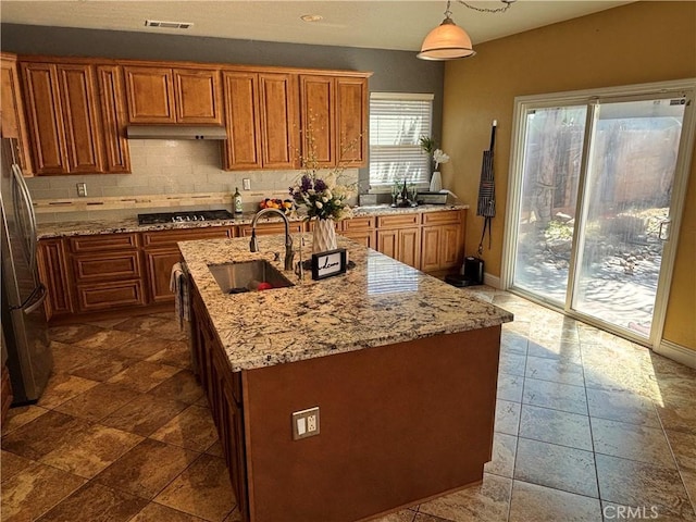 343 San Bernardino St, Los Banos, CA 93635 - kitchen featuring a sink, freestanding refrigerator, brown cabinets, and recessed lighting