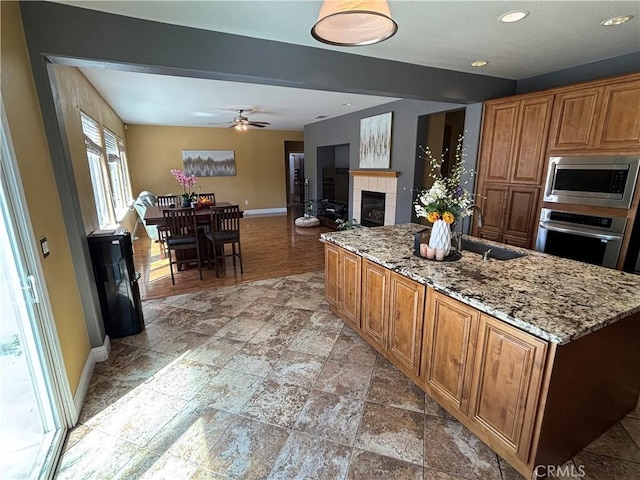 kitchen featuring stainless steel appliances, baseboards, recessed lighting, and a sink