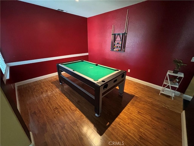 game room with baseboards, wood finished floors, and visible vents