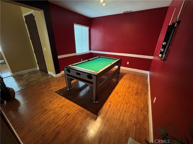 recreation room with baseboards, wood finished floors, and visible vents