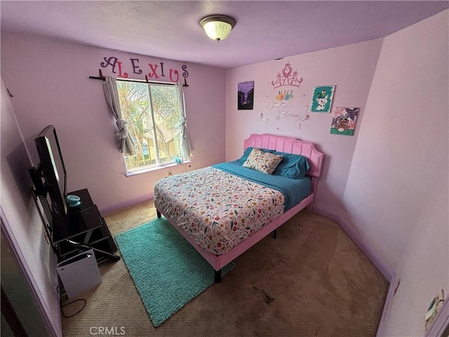 carpeted bedroom featuring baseboards