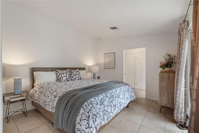 bedroom featuring visible vents, baseboards, and light tile patterned floors