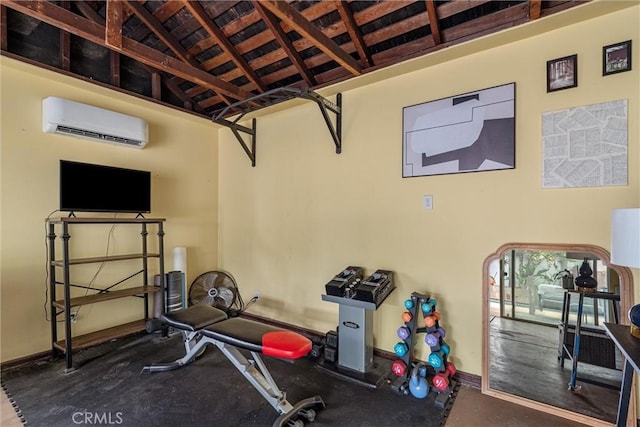 exercise room with baseboards, a wall mounted AC, and vaulted ceiling