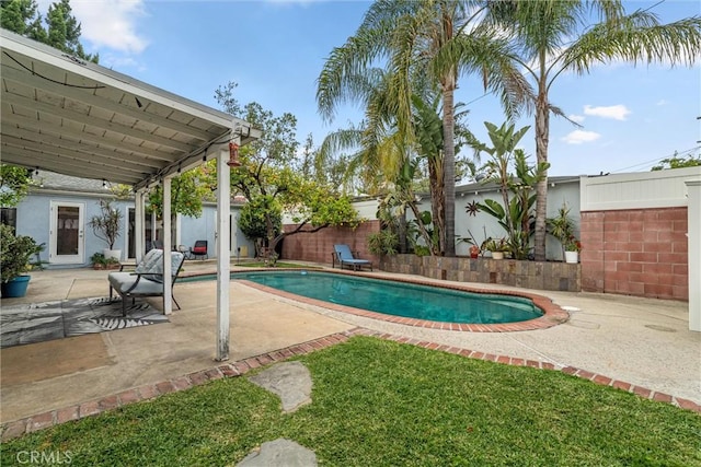 view of swimming pool with a fenced backyard, a fenced in pool, and a patio
