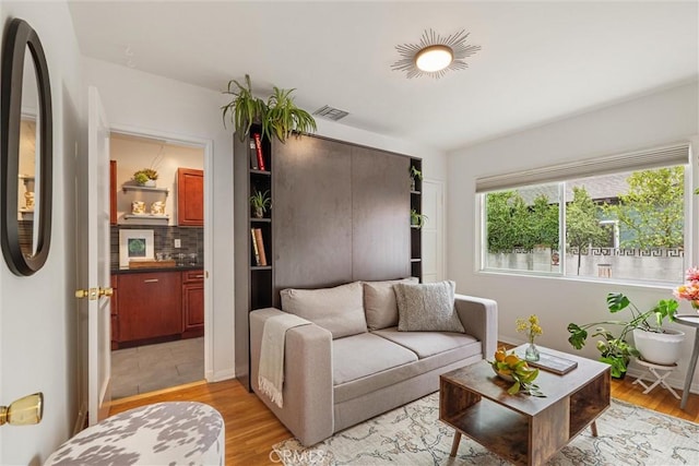living room featuring visible vents and light wood finished floors
