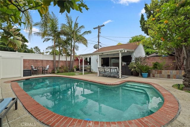 view of pool featuring a patio, a fenced in pool, and a fenced backyard