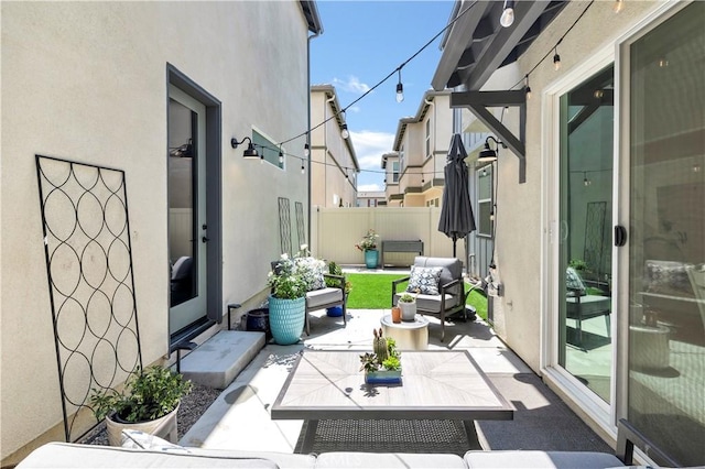 view of patio featuring an outdoor living space and a fenced backyard