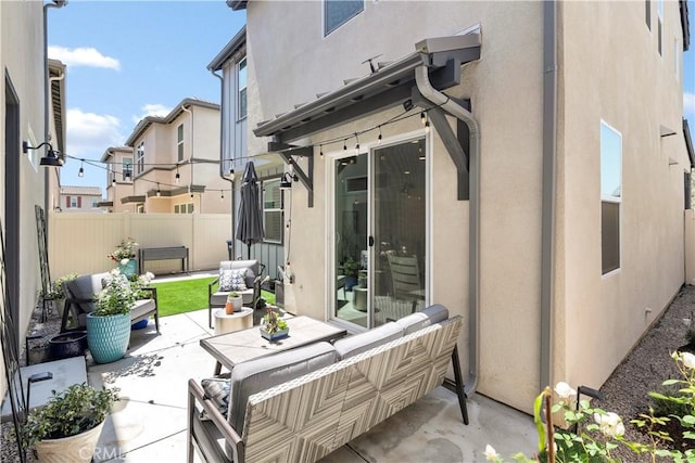 view of patio with fence and outdoor lounge area