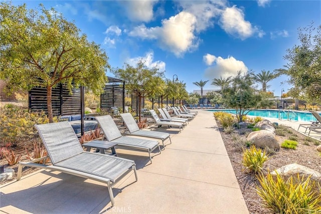exterior space featuring a pool and a patio