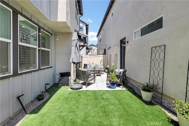 view of yard with a patio, an outdoor living space, and fence