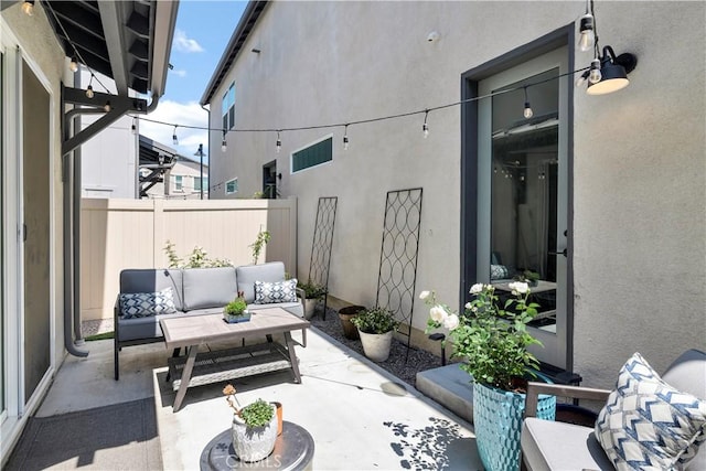 view of patio / terrace featuring fence and an outdoor hangout area