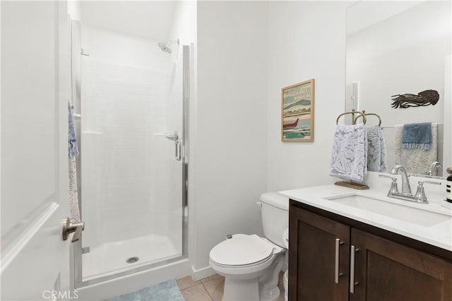 bathroom featuring toilet, tile patterned floors, a shower stall, and vanity