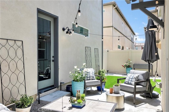 exterior space featuring a patio, fence, an outdoor living space, and stucco siding