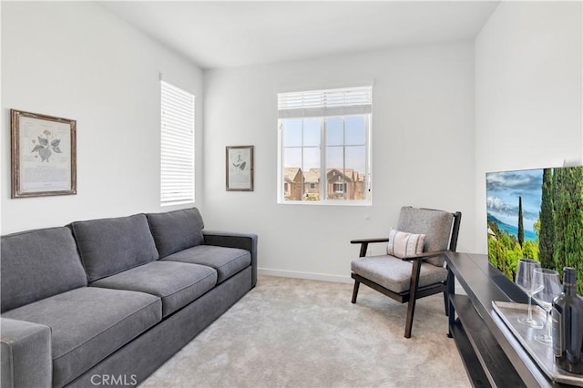 carpeted living room featuring baseboards