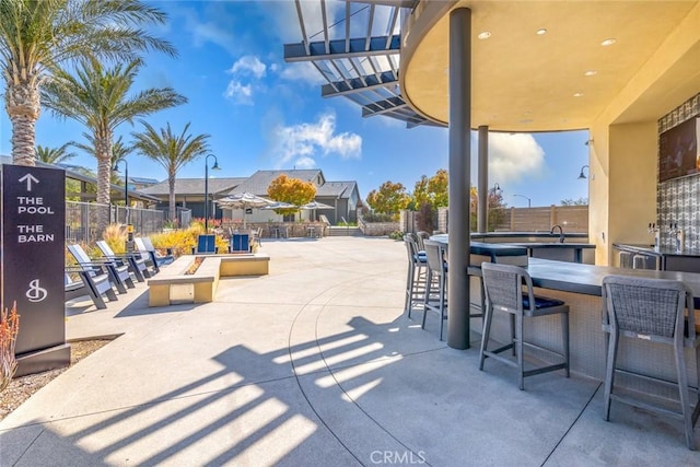 view of patio / terrace with fence and outdoor dry bar