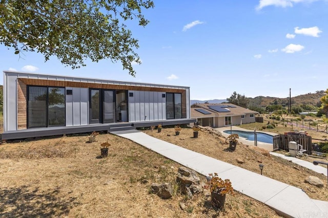 68256827 Kellyn Ln, Vista, CA 92084 - view of front facade featuring a mountain view, board and batten siding, and an outdoor pool