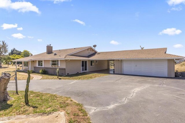 68256827 Kellyn Ln, Vista, CA 92084 - view of front facade with a garage, aphalt driveway, and a chimney