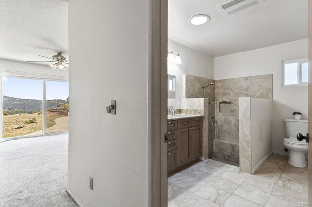 68256827 Kellyn Ln, Vista, CA 92084 - bathroom with visible vents, vanity, toilet, ceiling fan, and a walk in shower