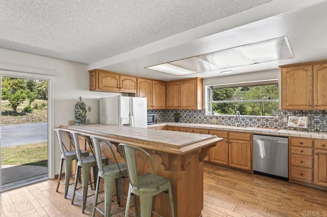 68256827 Kellyn Ln, Vista, CA 92084 - kitchen featuring appliances with stainless steel finishes, plenty of natural light, and light wood-type flooring