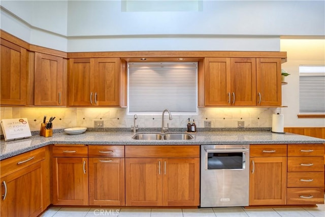 131 Serrano Hts, San Luis Obispo, CA 93405 - kitchen with a sink, dark stone counters, stainless steel dishwasher, and brown cabinetry