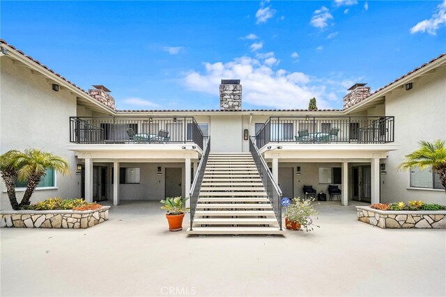 2486 Via Campesina, Palos Verdes Estates, CA 90274 - back of property featuring stucco siding, a chimney, a patio area, and a balcony