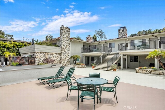 2486 Via Campesina, Palos Verdes Estates, CA 90274 - rear view of property featuring stucco siding, stairway, a chimney, a balcony, and a patio