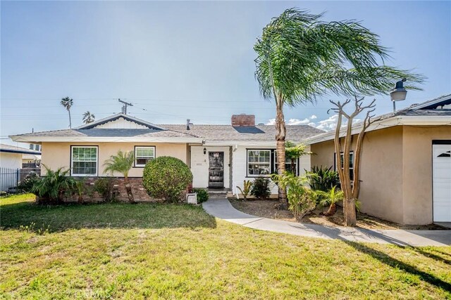 ranch-style home featuring fence, a front lawn, and stucco siding