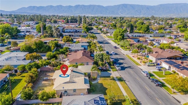 birds eye view of property with a mountain view and a residential view